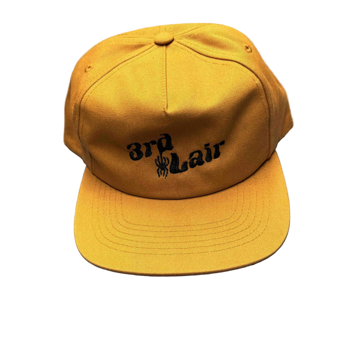 copper colored cap with text and logo on a gray surface