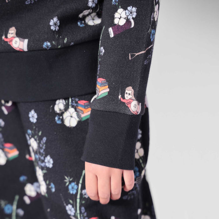 Close-up view of floral graphic print and ribbed cotton cuff detail