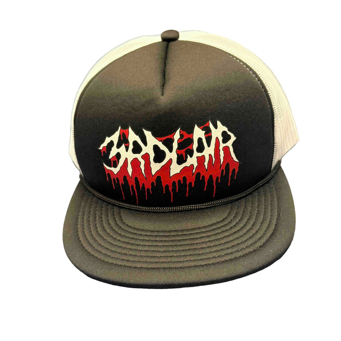 Trucker hat with a logo on a gray surface