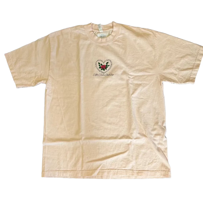 Beige t-shirt with a logo on a dark textured surface