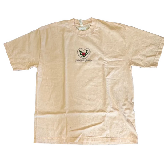 Beige t-shirt with a logo on a dark textured surface