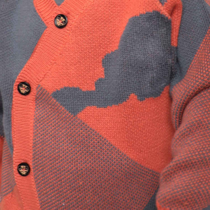 Close-up of soft organic cotton knit texture and wooden buttons on blue baby cardigan