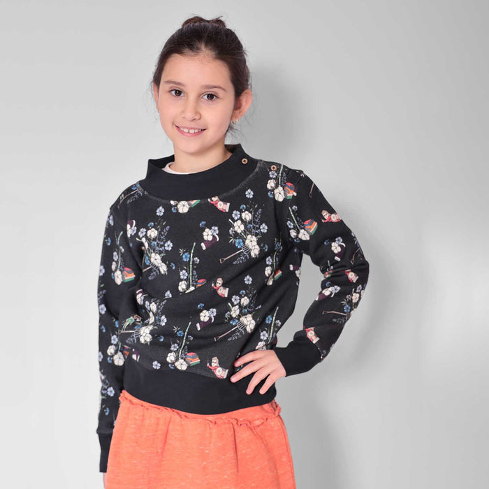 Child wearing a black floral print sweatshirt for everyday wear