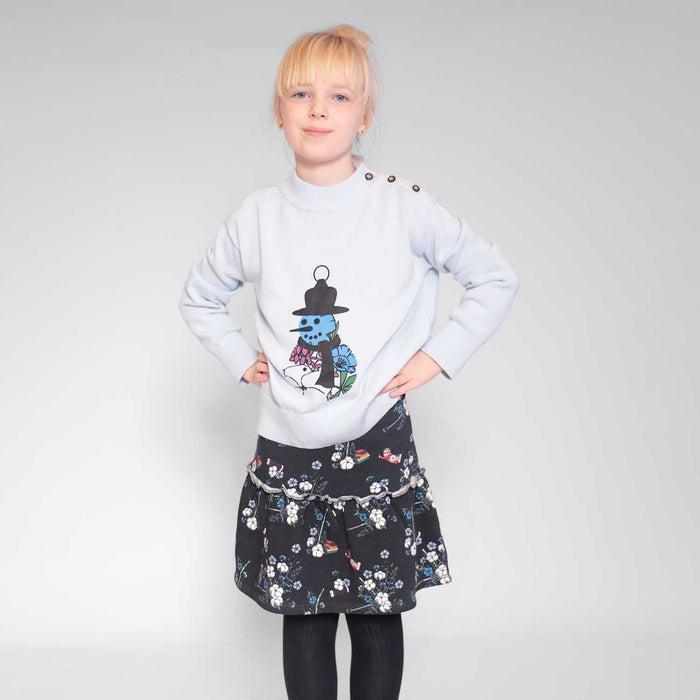 Girl wearing a black floral skirt paired with a Ligth blue Sweater