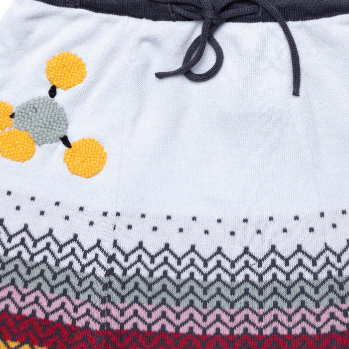 Detailed close-up of fine baby blue knit texture and delicate hem