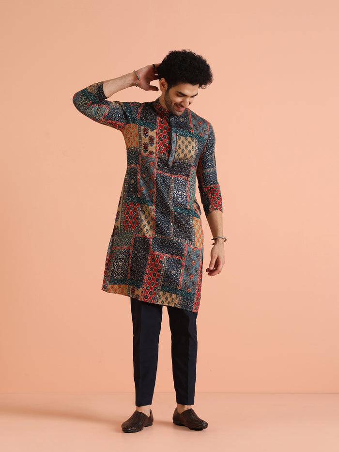 The model is posing with one hand raised to his head, wearing Kisah's multi colour kurta for men
