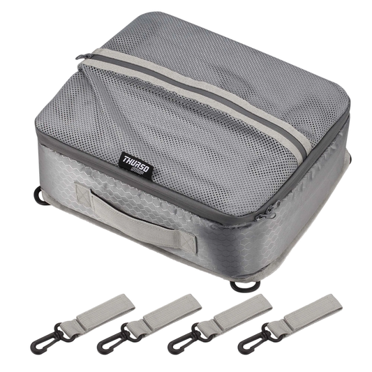 Gray travel packing cube with straps on a white background