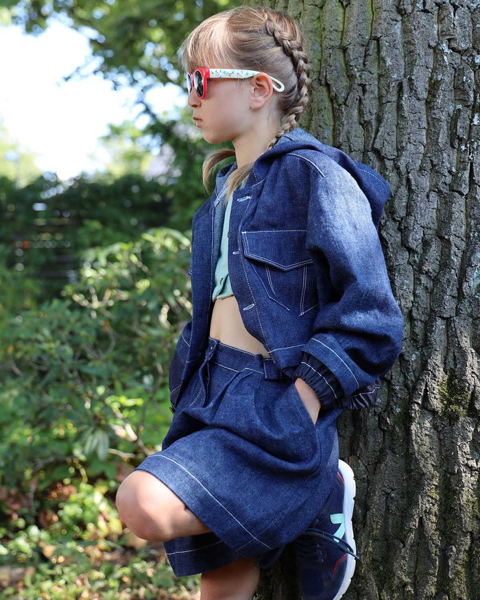 Child wearing wide-leg denim culottes paired with a cozy sweater
